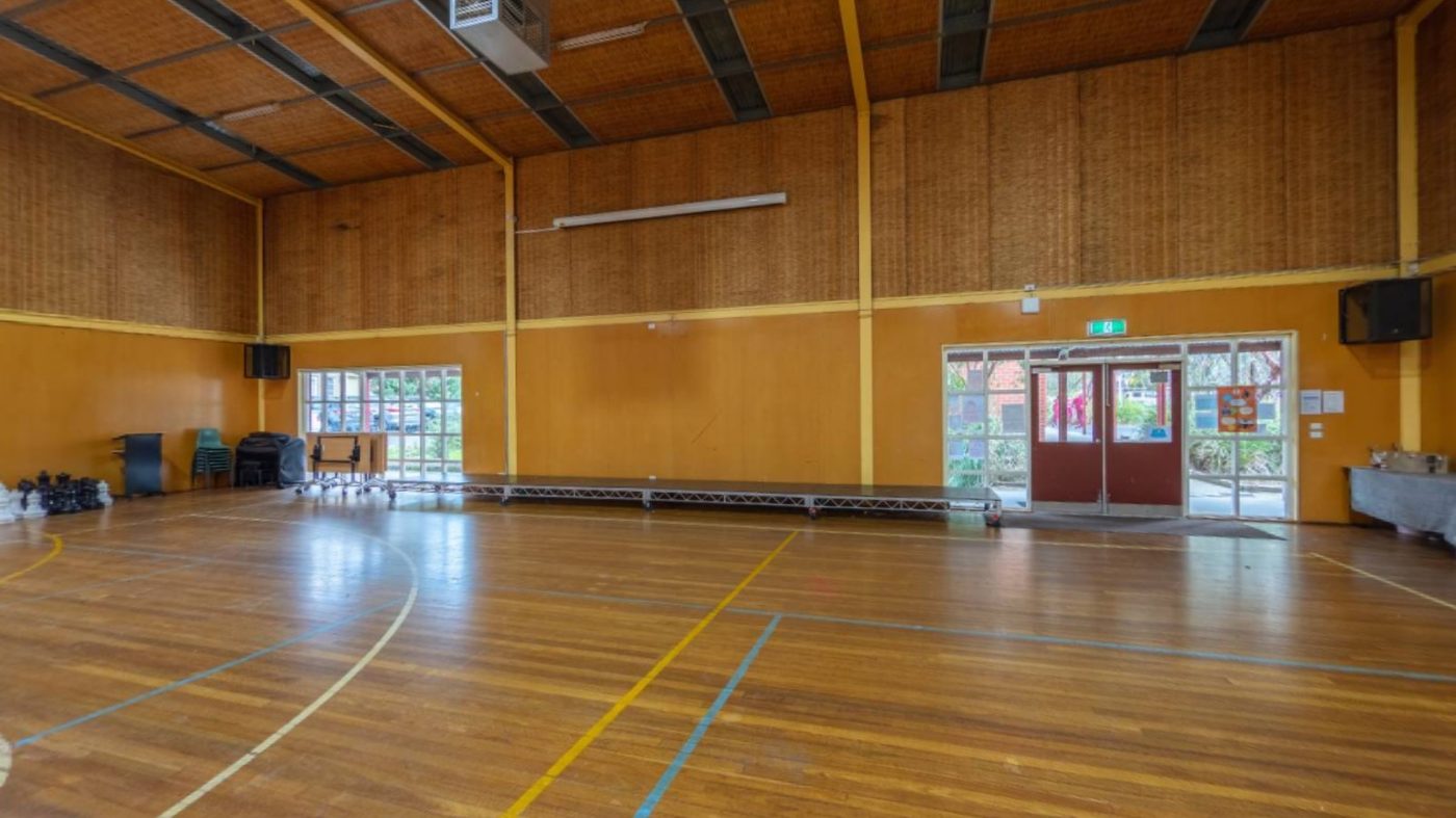 The 1990 school hall built by parent donations — half-sized for today's 550+ students